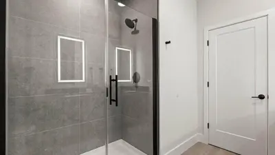 a shower with a glass door in a bathroom at Upstay-Luxury 3BR Home w Private Pool & Games Room in Orlando