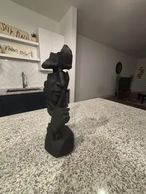 a statue of a person wearing a hat on a counter at Kissimmee Oasis in Orlando