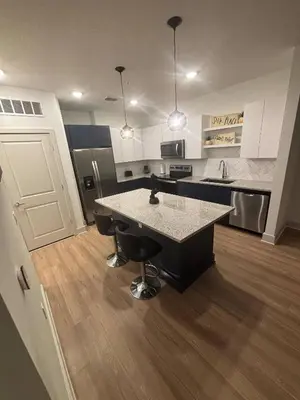 a large kitchen with a large island in the middle at Kissimmee Oasis in Orlando