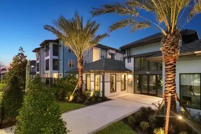 a house with palm trees in front of it at Kissimmee Oasis in Orlando