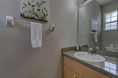 a bathroom with a sink and a mirror at Cozy Vacation Retreat in Fiesta Key Community in Kissimmee