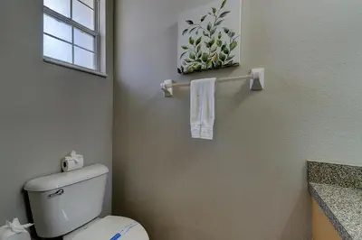 a bathroom with a white toilet and a window at Cozy Vacation Retreat in Fiesta Key Community in Kissimmee