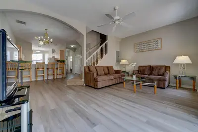 a living room with two couches and a dining room at Cozy Vacation Retreat in Fiesta Key Community in Kissimmee