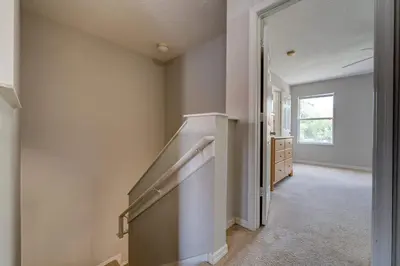 a hallway with a staircase in a house at Cozy Vacation Retreat in Fiesta Key Community in Kissimmee
