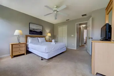 a bedroom with a bed and a ceiling fan at Cozy Vacation Retreat in Fiesta Key Community in Kissimmee