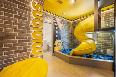 a room with a yellow slide in a brick wall at 15 Bedrooms 165 Bathrooms Sonoma 4171Sb in Kissimmee