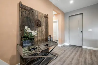a living room with a table with flowers on it at Luxury Family Townhouse Near Disney & Dining in Kissimmee
