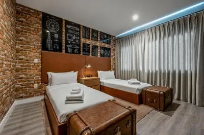 a bedroom with two beds and a brick wall at Luxury Family Townhouse Near Disney & Dining in Kissimmee