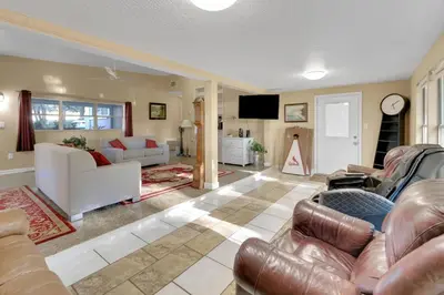a living room with couches and a tv at Orlando 3BR | Hot Tub + Parking + Pets in Orlando