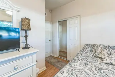 a bedroom with a bed and a flat screen tv at Orlando 3BR | Hot Tub + Parking + Pets in Orlando