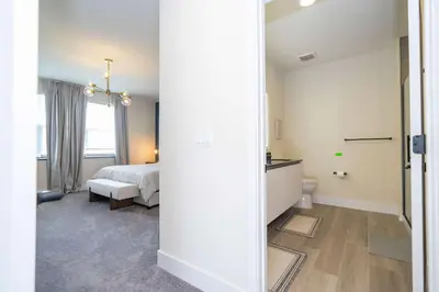 a bedroom with a bed and a bathroom at Family Friendly w Pool near Disney at Serenity 1420 in Orlando