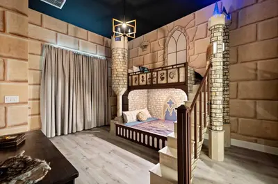 a castle themed bedroom with a bed in a brick wall at Grand 15-Bedroom Villa -Magical Themes, Pool & Game Loft, Lakeview in Kissimmee