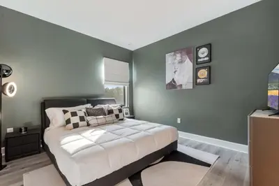 a bedroom with a bed and a green wall at Grand 15-Bedroom Villa -Magical Themes, Pool & Game Loft, Lakeview in Kissimmee