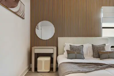a bedroom with two beds and a mirror on the wall at Grand 15-Bedroom Villa -Magical Themes, Pool & Game Loft, Lakeview in Kissimmee