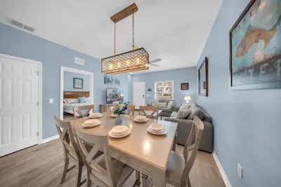 a dining room and living room with a table and chairs at 3204 GL - Serene Lucaya Oasis Retreat in Kissimmee