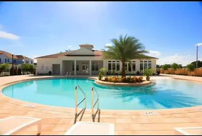 a large swimming pool with a house in the background at 3204 GL - Serene Lucaya Oasis Retreat in Kissimmee
