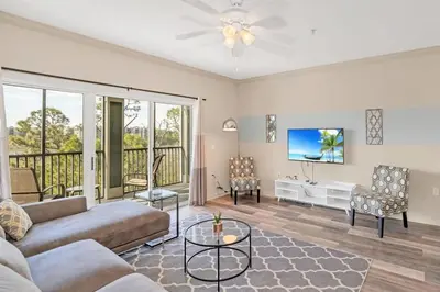 a living room with a couch and a tv at Pet-Friendly Condo w Pool Near Disney in Orlando