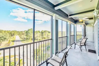 a balcony with two chairs and a large window at Upstay Modern 3BR Getaway w Pool in Orlando