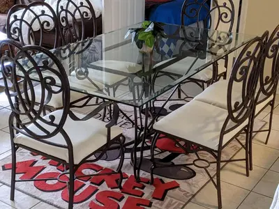 a glass dining table and chairs with a glass table and chairs at Water Park & Fantastic Pool only Minutes To Walt Disney World's Front Gate!!! in Orlando