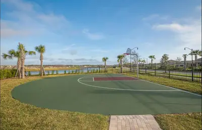 a basketball court in a park with palm trees at 2 Bedrooms Apartment in Storey Lake in Kissimmee