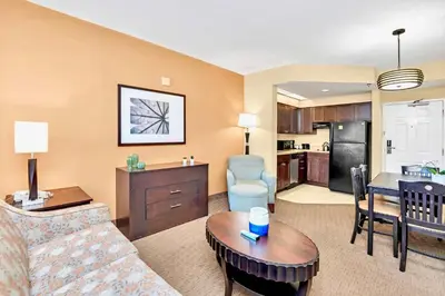 a living room with a couch and a table at Comfortable Suite Near Disney w Pool and Hot Tub in Orlando