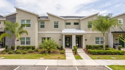 a house with palm trees in front of it at Stylish Home & Free Resort Access 2420 in Kissimmee