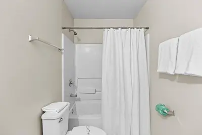 a bathroom with a white shower curtain and a toilet at Amazing 4 Bedrooms- Near Disney in Kissimmee
