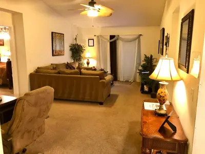 a living room with a couch and a table at Plutospad in Orlando