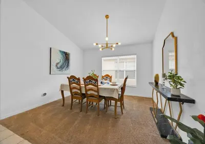 a dining room with a table and chairs at Spacious Emerald Home - Pool and Lanai Near Disney in Kissimmee
