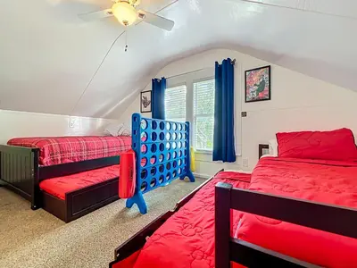 a bedroom with two beds and a ceiling fan at 1920s Rustic Cabin, 20 Min to Disney and Nightlife in Orlando