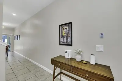 a white room with a wooden table with flowers on it at Resort Fun Star Wars Toy Story Rooms Near Disney in Kissimmee