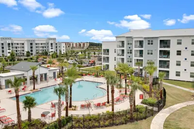 an aerial view of a resort with a pool and palm trees at 3 Bedrooms 2 Bathrooms Storey Lake 3141-306 in Kissimmee