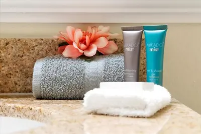 a bathroom counter with some products on a table at Luxurious Condo near DisneyLand in Orlando