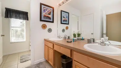 a bathroom with two sinks and a large mirror at MNL2696 in Orlando