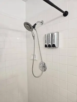 a shower with a shower head in a bathroom at Beauty 4 miles to Disney 3Br 2Ba Pool Home in Kissimmee