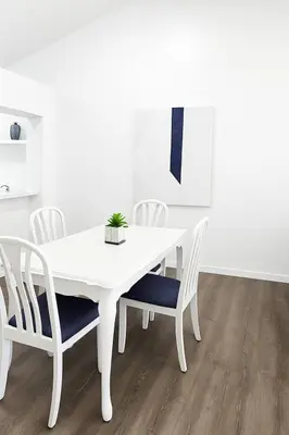 a white dining room table and chairs with a plant on it at Beauty 4 miles to Disney 3Br 2Ba Pool Home in Kissimmee