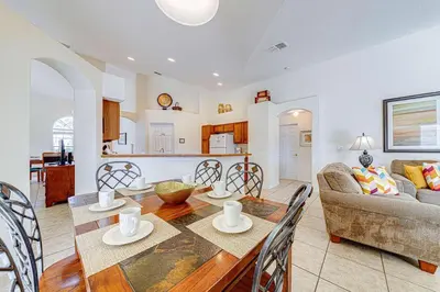 a kitchen and living room with a table and chairs at Great Location With Conservation Views in Orlando