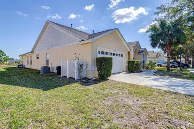 a house with a driveway and a garage at Great Location With Conservation Views in Orlando