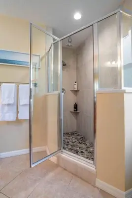 a shower with a glass door in a bathroom at Large 3 bedroom with King Bed in Orlando