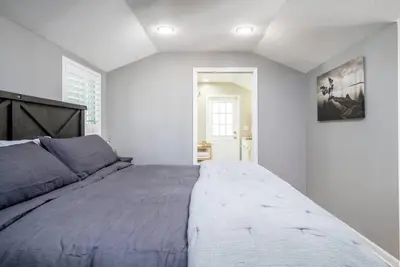 a bedroom with a large bed in a white room at Massive 3 bedroom with large backyard in Orlando