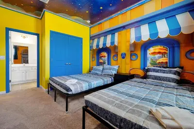 two beds in a room with a star ceiling at Luxury and Sophisticated 15 BR ensuite in Kissimmee