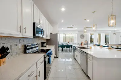 a kitchen with white cabinets and a white counter top at Luxury and Sophisticated 15 BR ensuite in Kissimmee