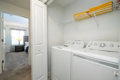 a white laundry room with a washer and dryer at Beautiful 4 BR close to Disney in Kissimmee
