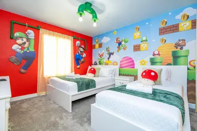 a bedroom with two beds with mario characters on the wall at Beautiful 4 BR close to Disney in Kissimmee