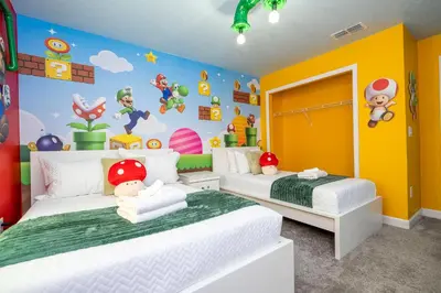 two beds in a childs bedroom with cartoon characters at Beautiful 4 BR close to Disney in Kissimmee