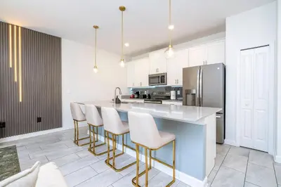 a kitchen with a large island with bar stools at Beautiful 4 BR close to Disney in Kissimmee
