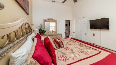 a living room with a couch and a flat screen tv at FP8157 - Windsor Palms Resort 4 Bedroom Home With Game Room in Kissimmee