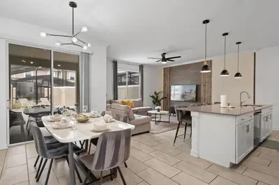 a kitchen and living room with a table and chairs at Refúgio Incrível a 10 Min da Disney – Storey Lake in Kissimmee