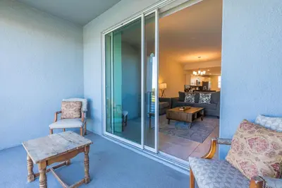 a living room with a couch and a table at Comfortable 2BR Condo w Lake Views in Kissimmee