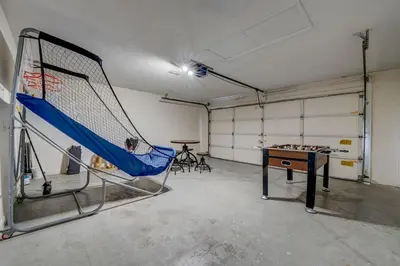 a room with a net and a table in it at Sun Kissed Pool Home in Kissimmee in Kissimmee